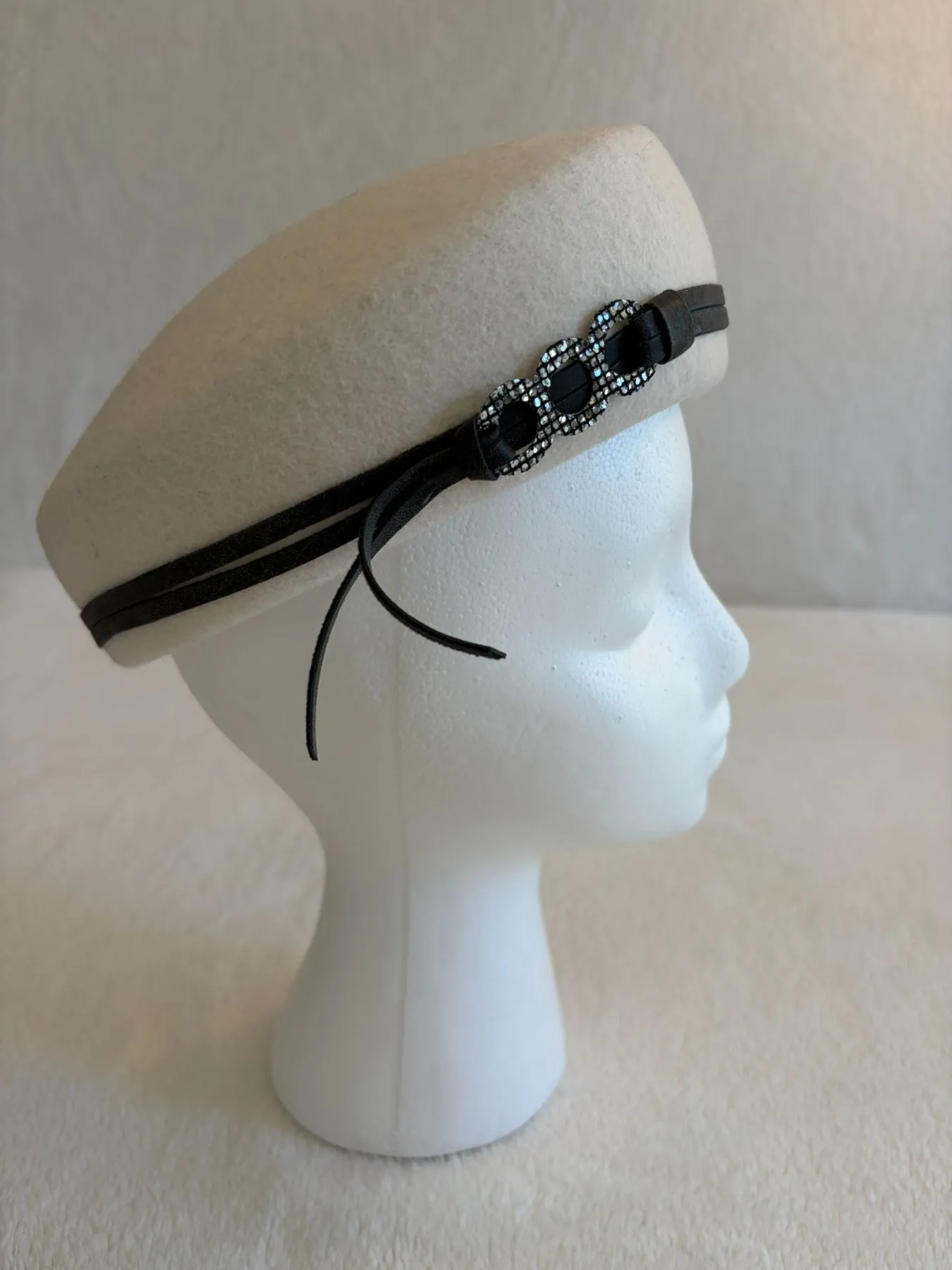 A cream felt pillbox hat from Hats by Cherish, number 203