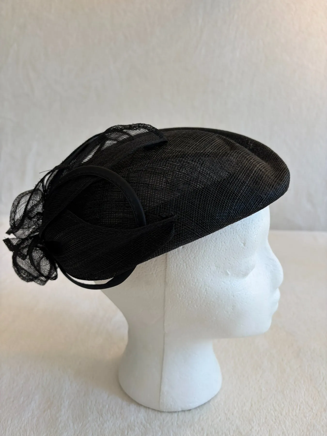 A black straw fascinator from Hats by Cherish, number 277