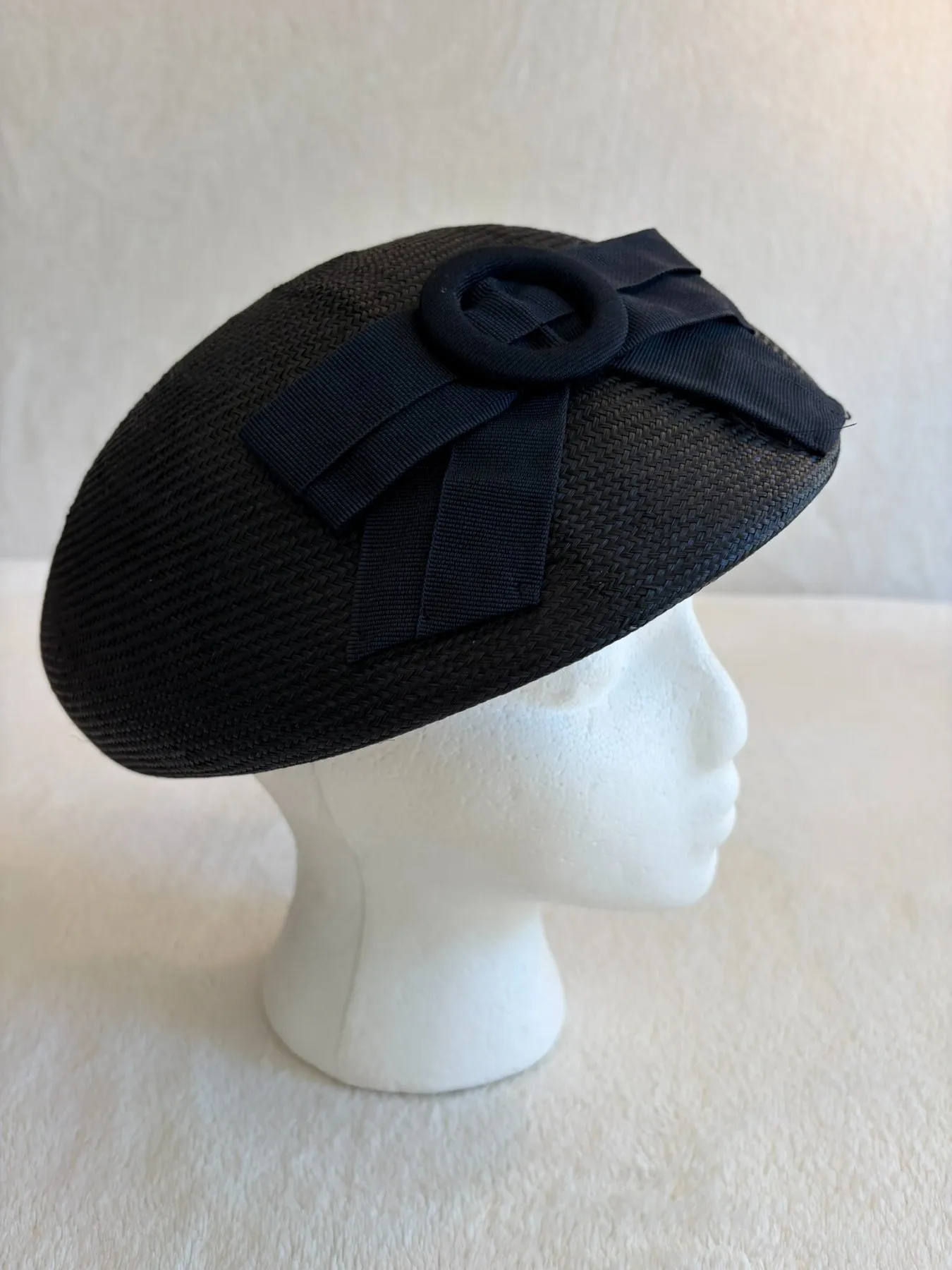 A navy straw pillbox hat from Hats by Cherish, number 377