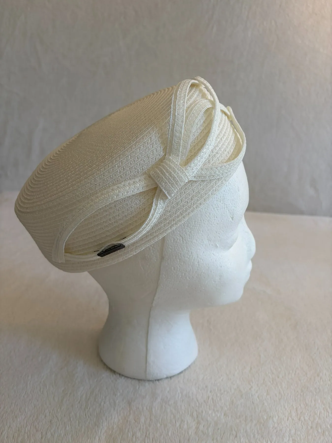 A cream straw pillbox hat from Hats by Cherish, number 574
