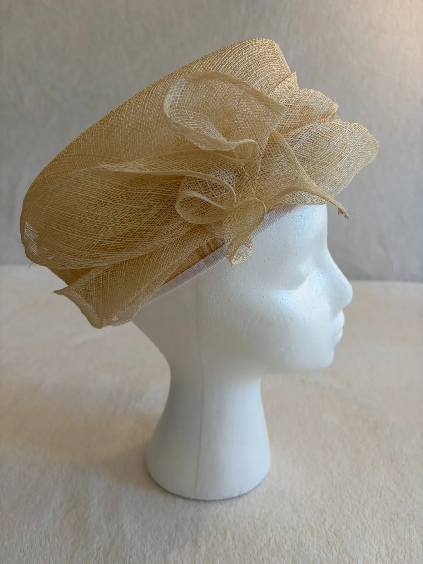 A beige and tan straw pillbox hat from Hats by Cherish, number 768