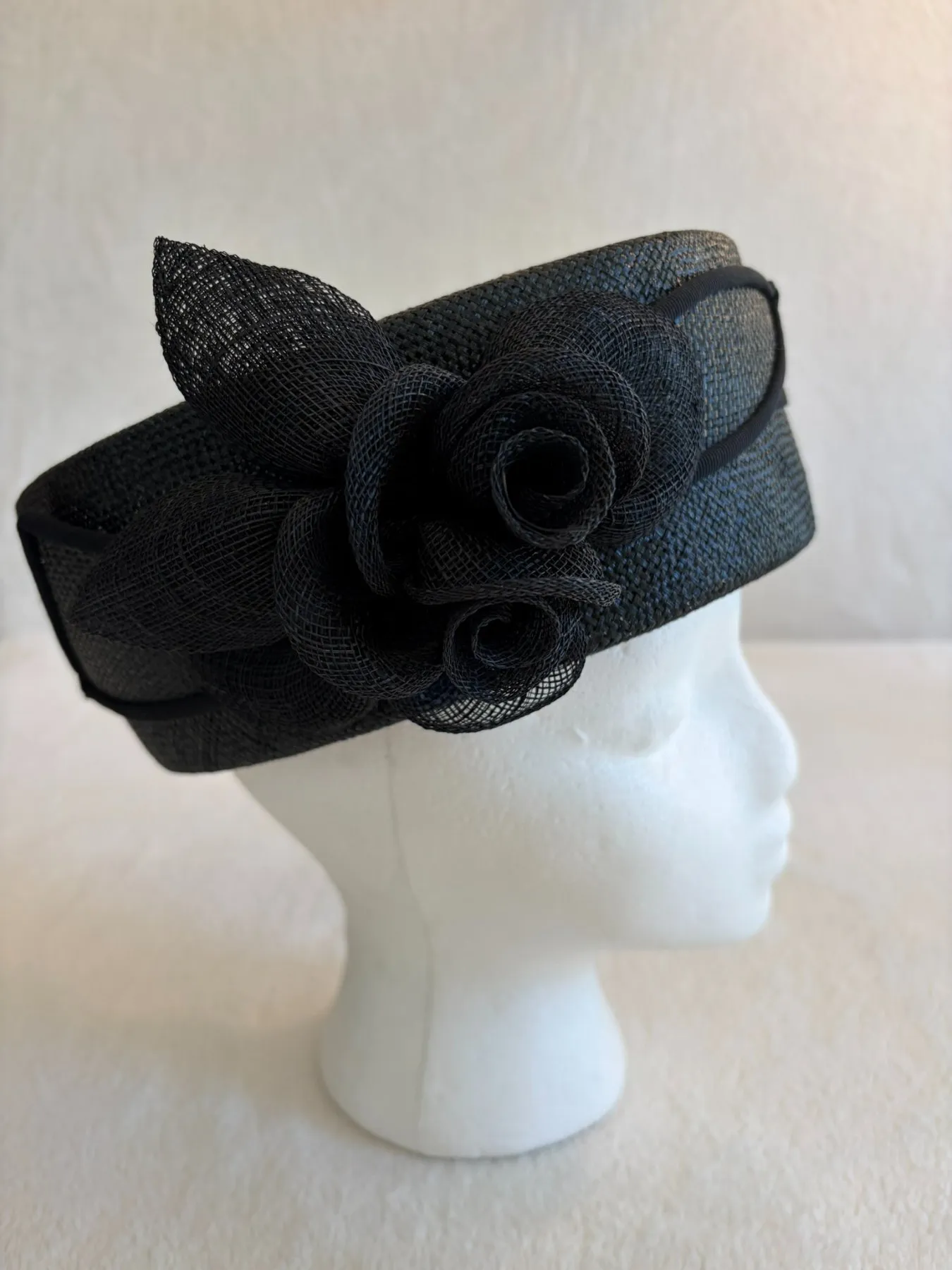A black straw pillbox hat from Hats by Cherish, number 799