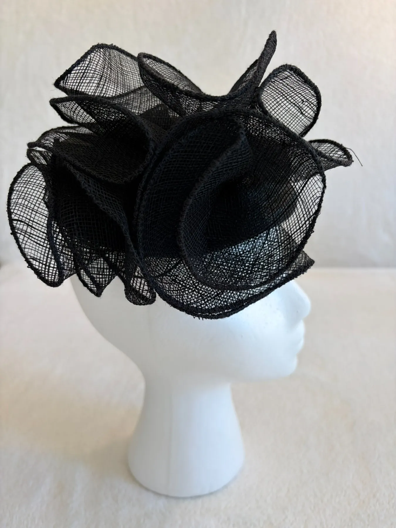 A black straw fascinator from Hats by Cherish, number 806